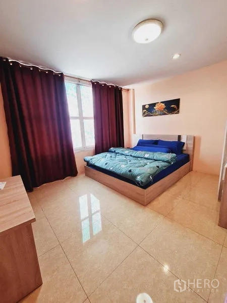 Shophouse for sale in Lam Luk Ka, Pathum Thani - Bright bedroom with large window, blackout curtains and double bed on tiled floor.