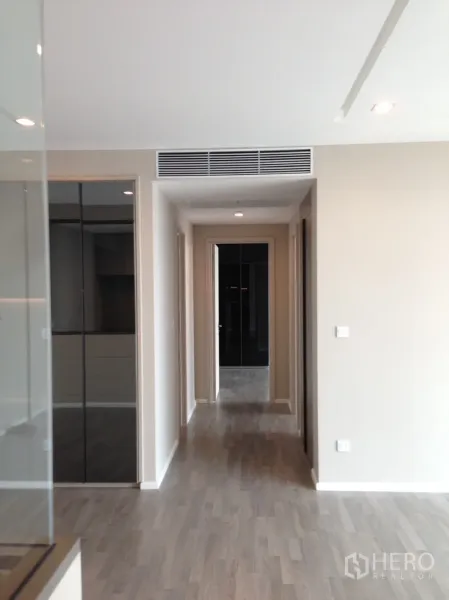 Condominium for rent in Bang Sue, Bangkok - Bright hallway with wood floors, recessed lights and concealed air vent.