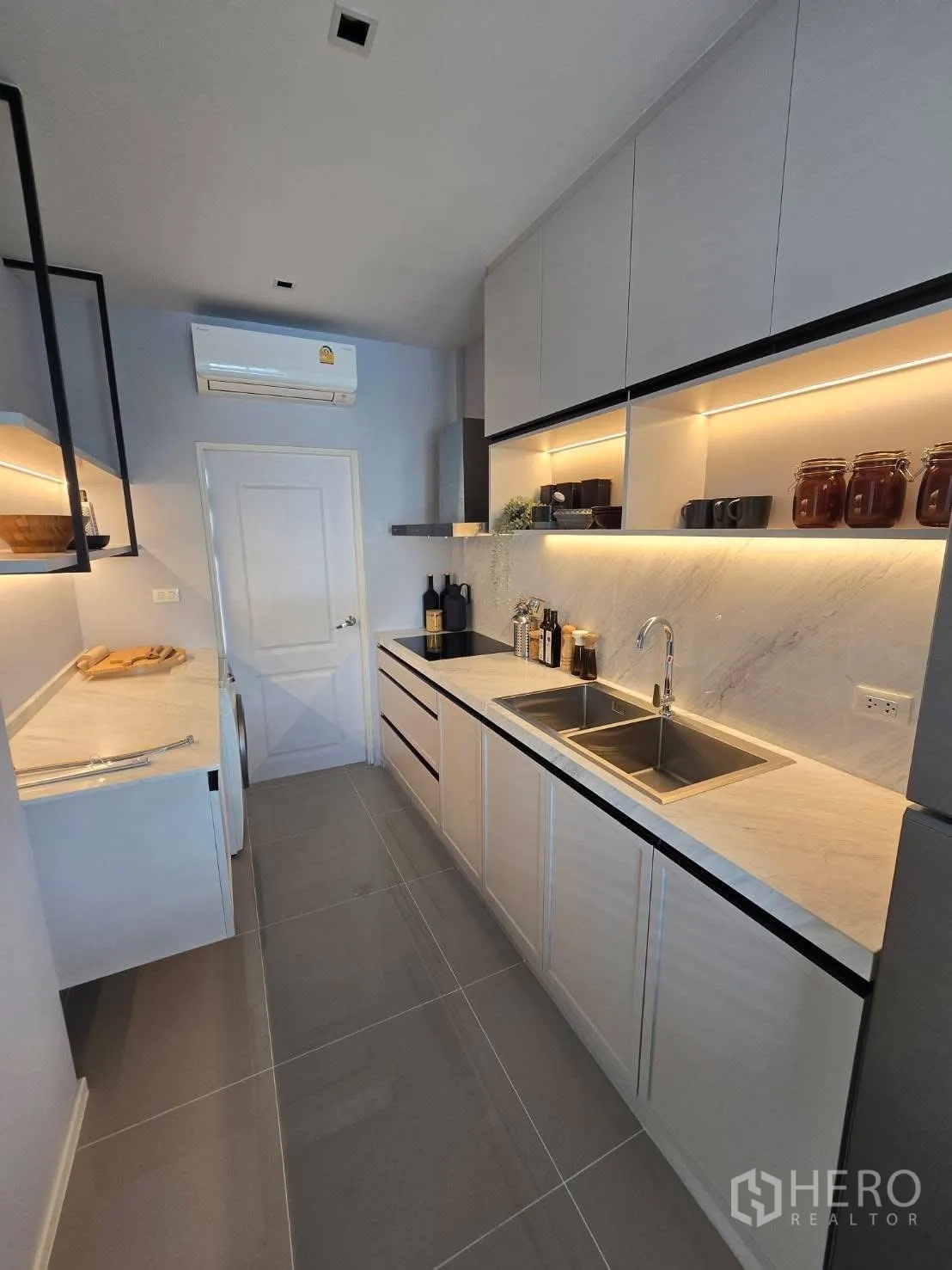 Semi-detached House for rent in Bang Phli, Samut Prakan - Second view of the kitchen showing ample storage and double basin.