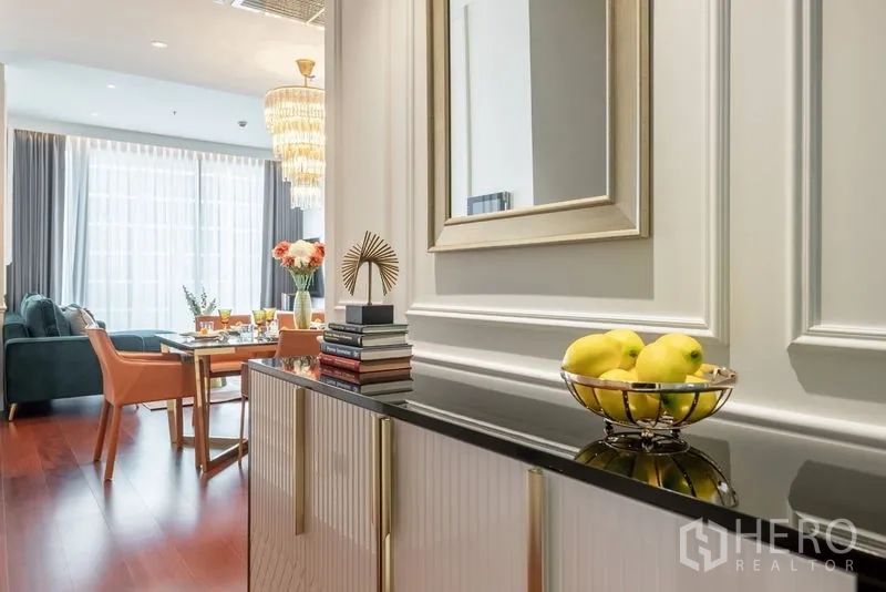 公寓 出租或出售在Watthana, Bangkok - 走廊柜台与镜子，摆放书本和果盘，通向餐客区