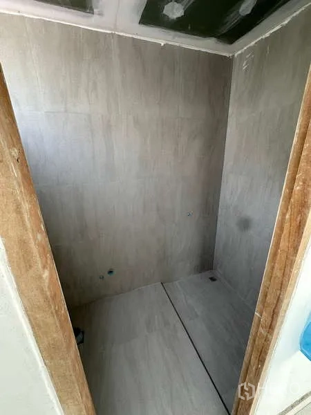 Home Office for sale in Bang Phli, Samut Prakan - Unfinished tiled restroom area prepared for sanitary fixtures inside the property.