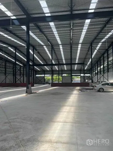 Warehouse for rent in Mueang Samut Sakhon, Samut Sakhon - Spacious high-bay warehouse interior with steel columns, skylight roof panels and polished concrete floor in Mueang Samut Sakhon.