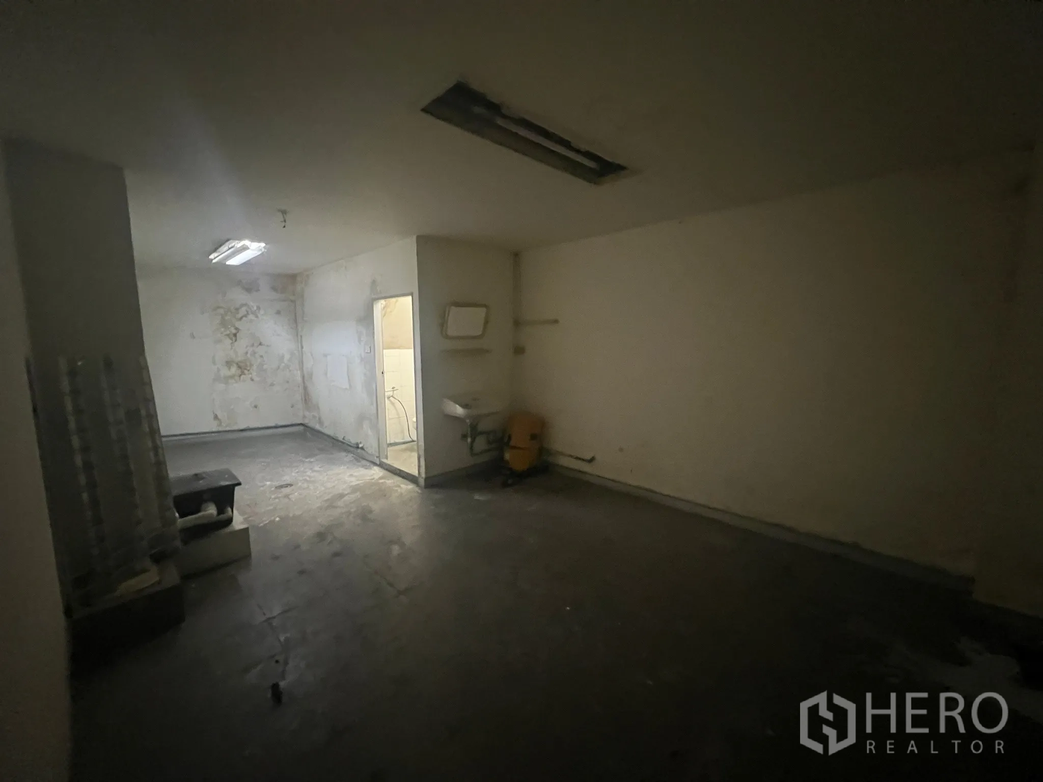 店屋 出租在Watthana, Bangkok - 功能间带洗手池并通向卫生间，墙面为原始使用状态。