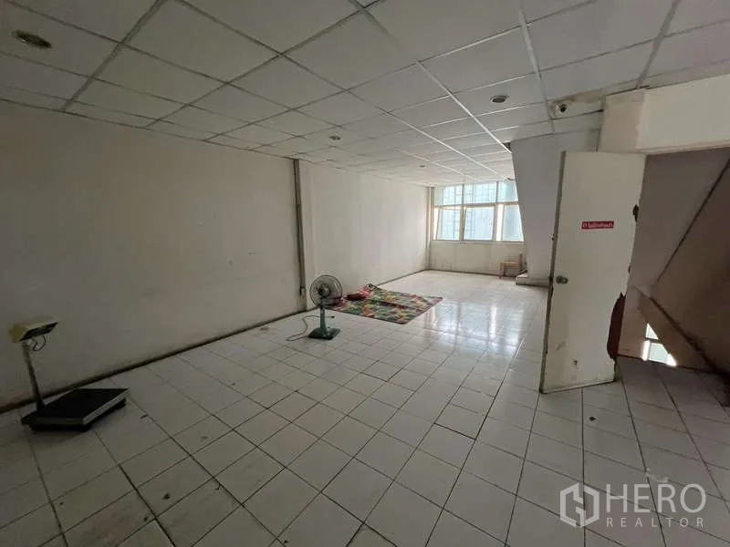 店屋 出租或出售在Khlong Toei, Bangkok - 铺设瓷砖的空房间，吊顶与窗户，适合办公或储物