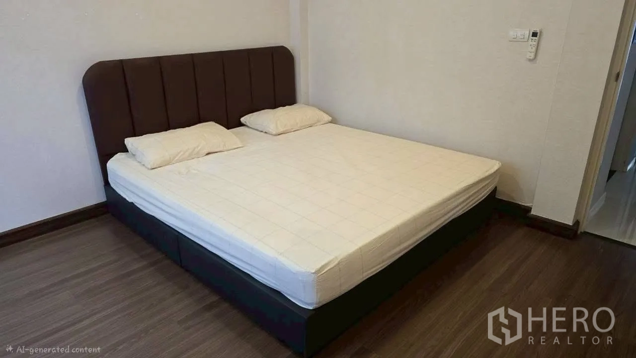 Detached House for rent in Prawet, Bangkok - Bedroom with large bed on wood flooring and neutral painted walls.
