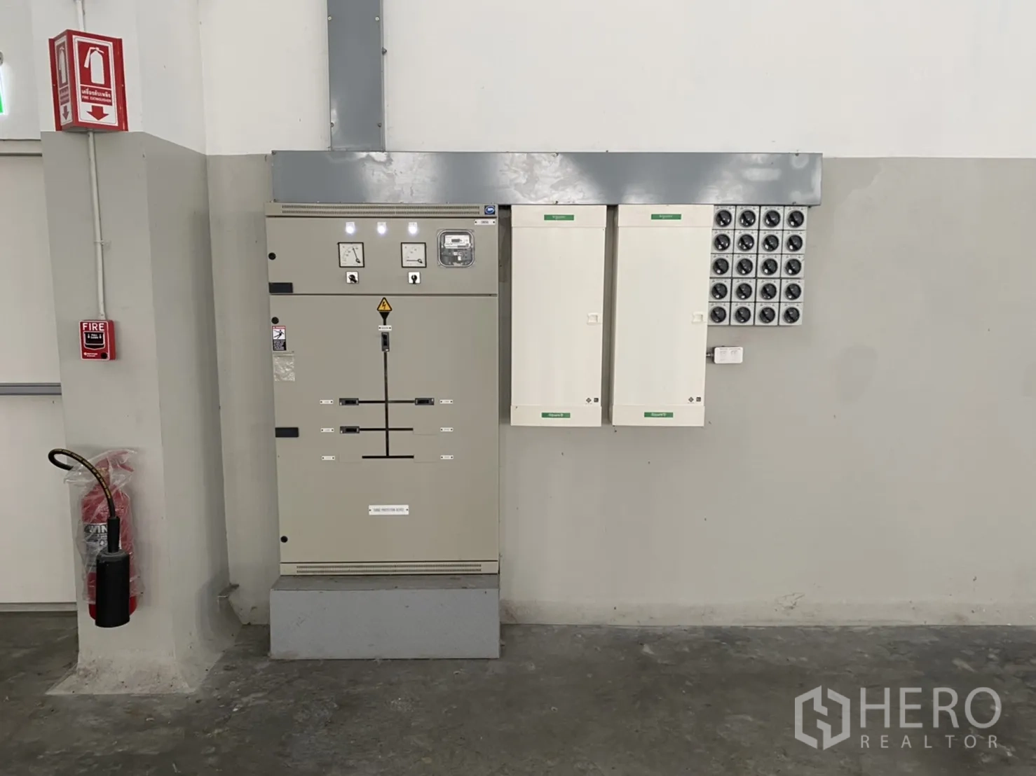 Warehouse for rent in Chachoengsao - Electrical control panels and fire safety equipment mounted on an interior wall.