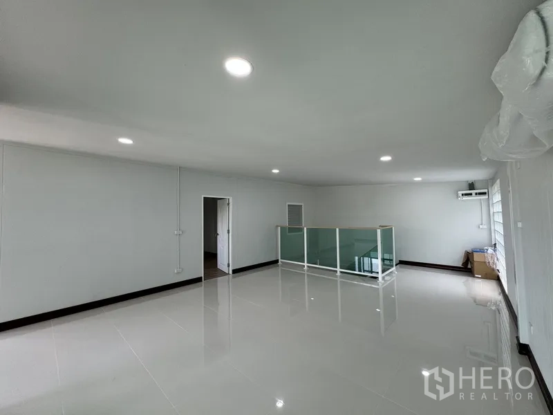 Townhouse for sale in Bueng Kum, Bangkok - Open-plan upper level with large windows and air conditioning.
