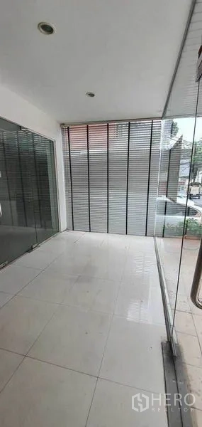 Home Office for rent in Watthana, Bangkok - Covered foyer with floor-to-ceiling glass and blinds.