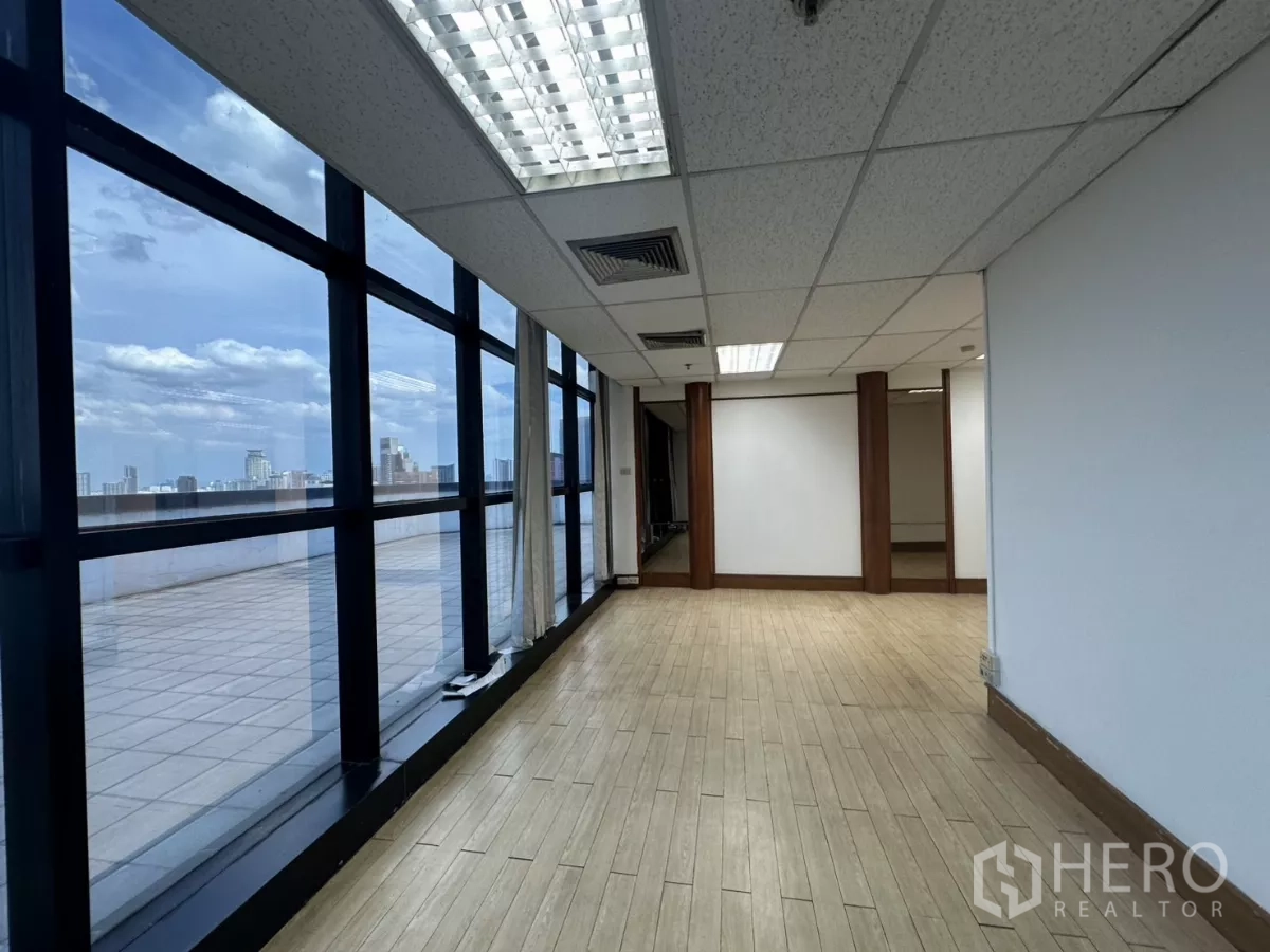 Office Space for rent in Watthana, Bangkok - Window-lined room opening to a broad outdoor terrace with skyline views.