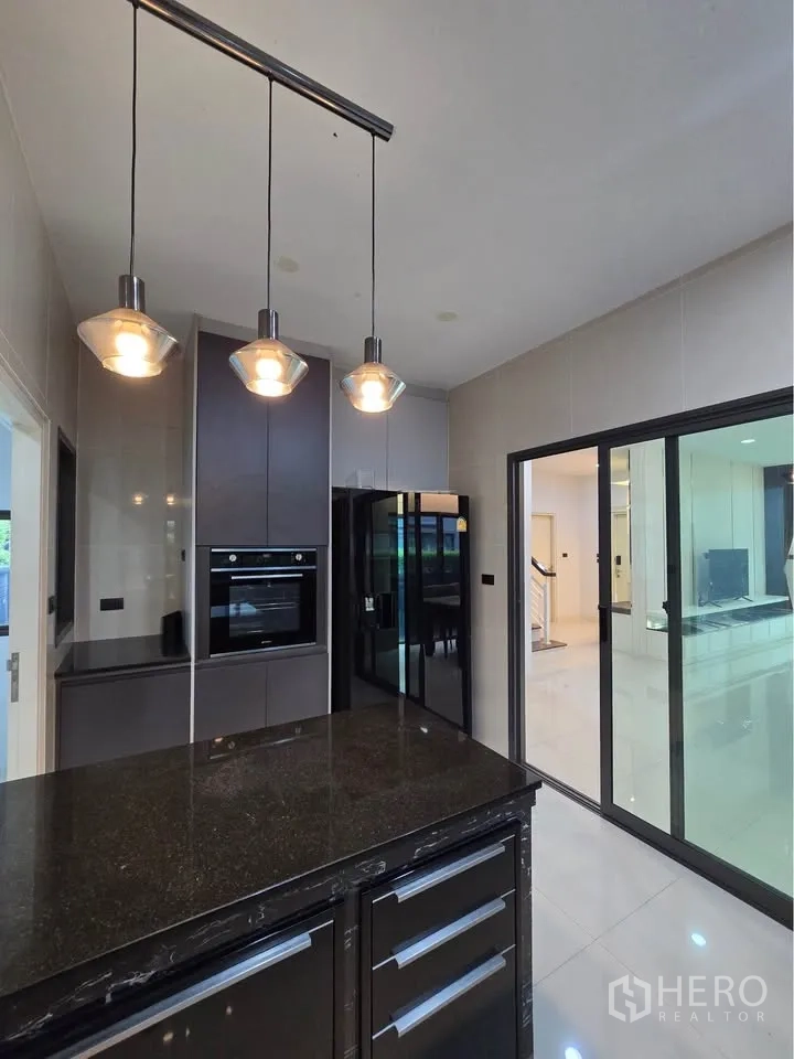 บ้านเดี่ยว for rent in Bang Kapi, Bangkok - ห้องครัวไอส์แลนด์ท็อปหิน แขวนโคมไฟ และเตาอบบิลต์อิน