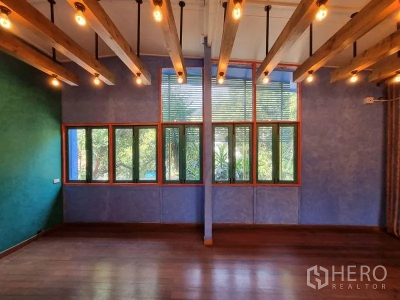 Detached House for rent in Khlong Toei, Bangkok - Room with long band of windows, exposed beams and garden outlook.