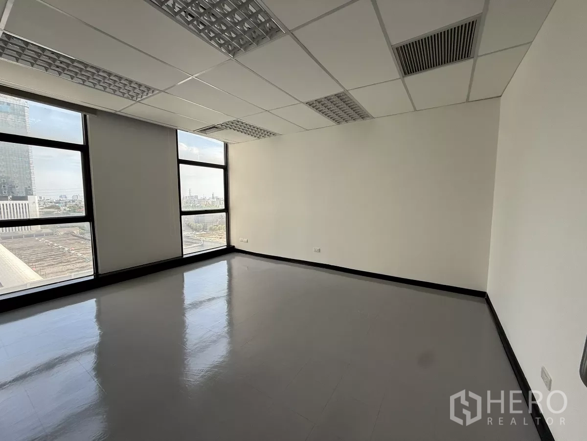 Office Space for rent - Corner office with large glazing, Bangkok city views and reflective tile flooring.