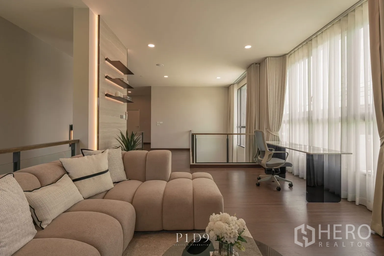 Detached House for rent in Bang Phli, Samut Prakan - Open family area with curved sofa, long desk and floor-to-ceiling sheer curtains.