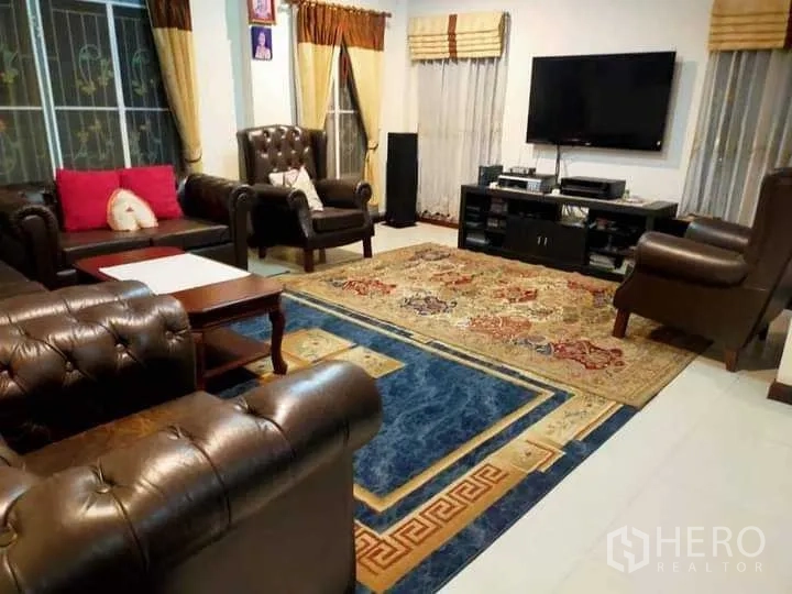 บ้าน ขายในPrawet, Bangkok - มุมห้องนั่งเล่น ชั้นวางทีวี พรมลายสวย และชุดโซฟาหนัง