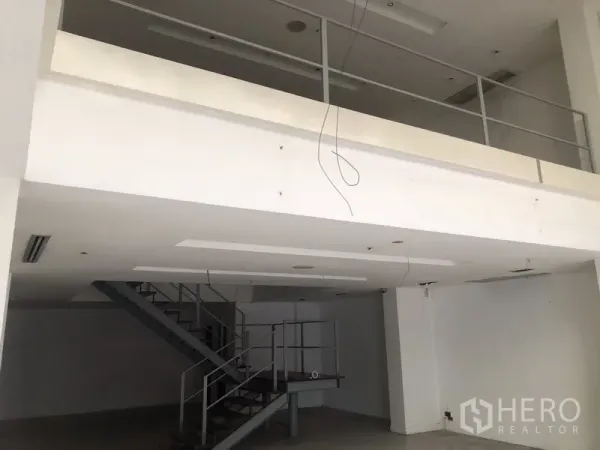 Home Office for rent in Khlong Toei, Bangkok - Open-plan home office interior with mezzanine level and metal staircase.