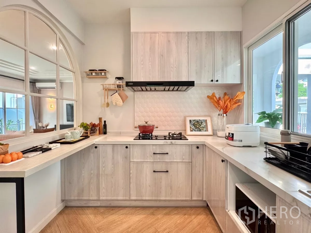 Detached House for rent in Bang Phli, Samut Prakan - Light wood kitchen with L-shaped counters, gas hob and window.