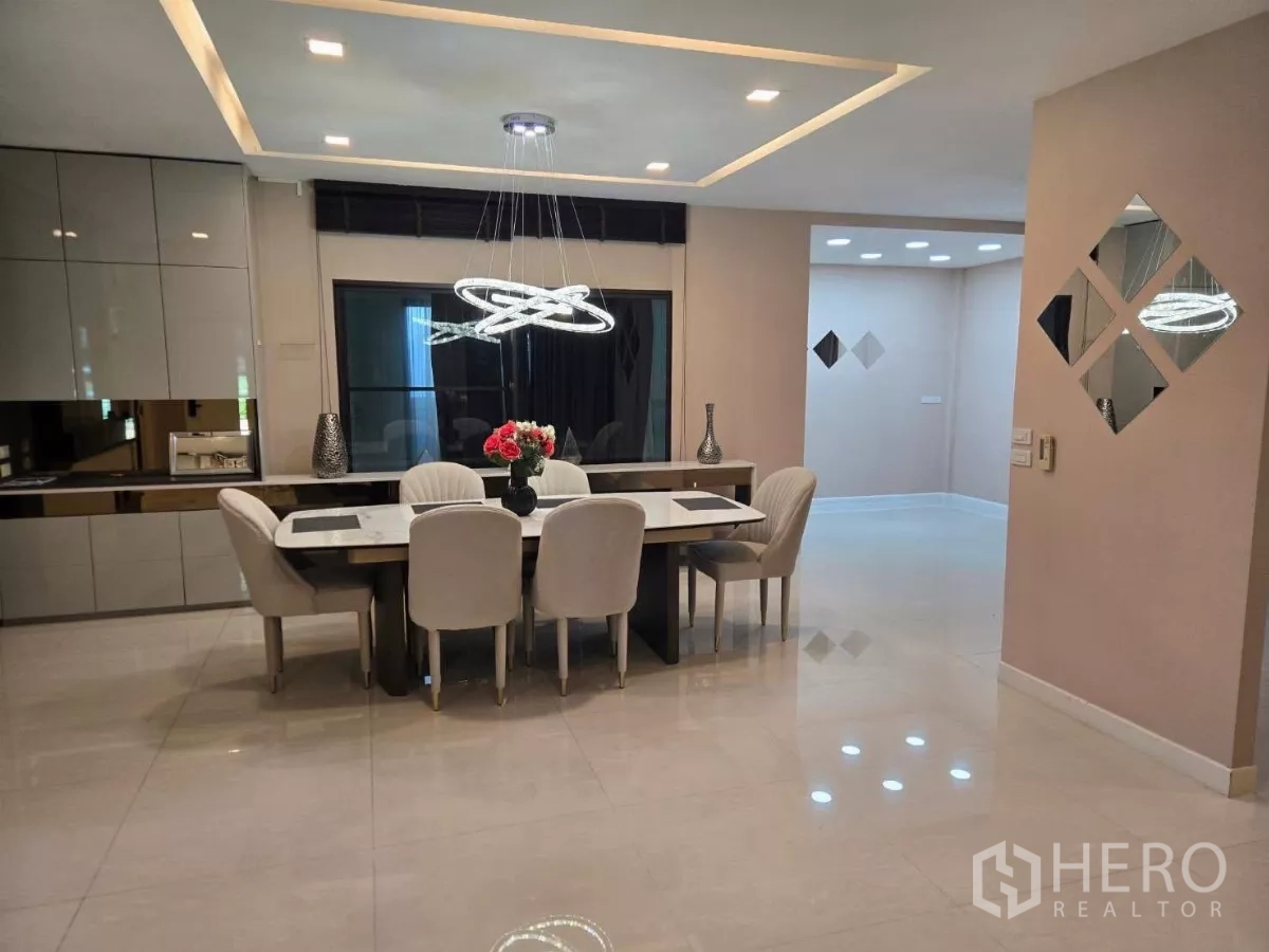 Detached House for rent or sale in Bang Phli, Samut Prakan - Elegant dining room with built-in cabinetry, sculptural pendant lights, and a six-seat table.