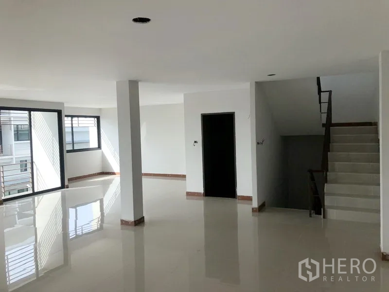 Factory for rent or sale in Bang Bua Thong, Nonthaburi - Bright upper office space with sliding windows, balcony railings and stairwell.