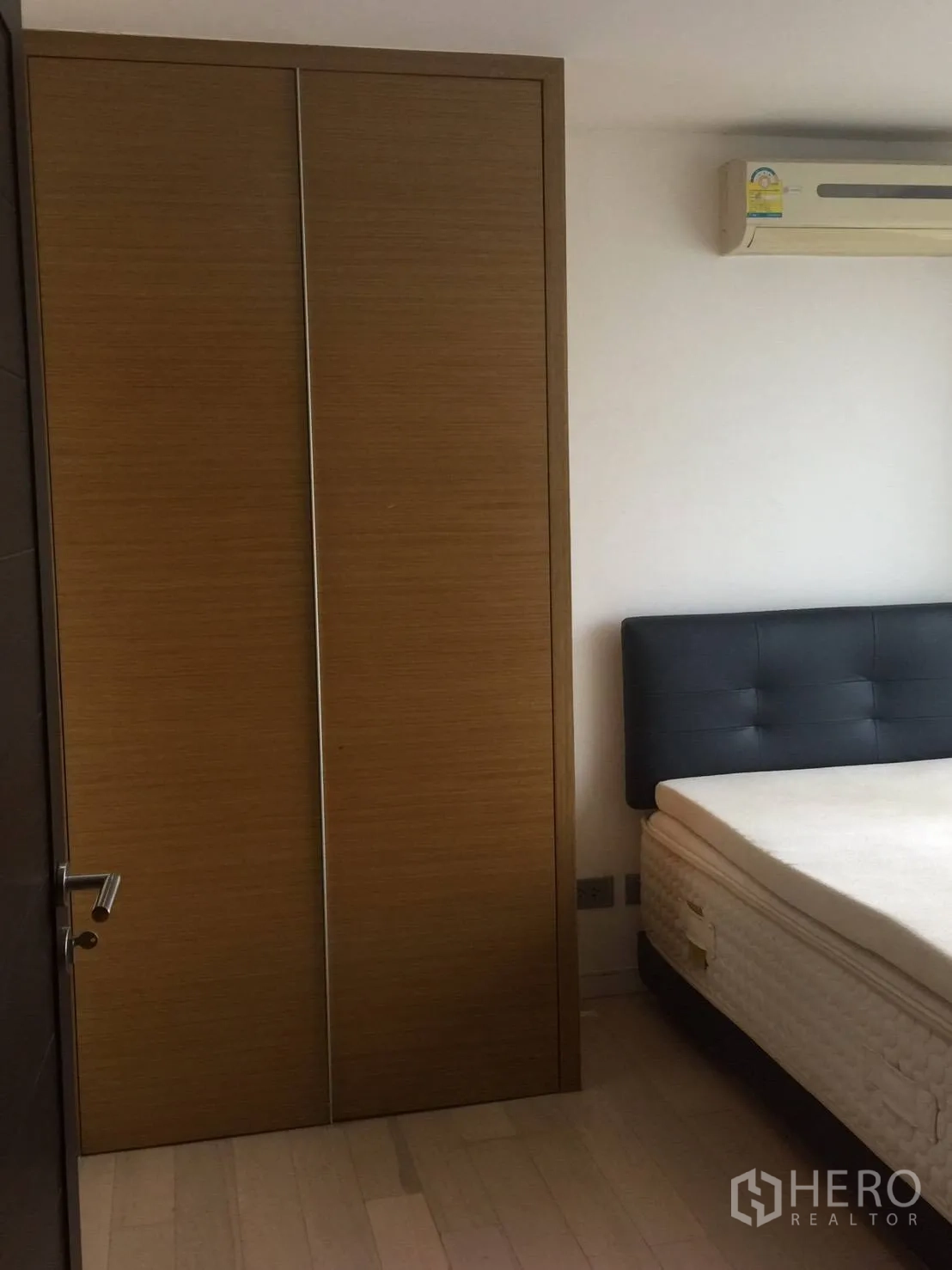 Condominium for rent in Watthana, Bangkok - Spacious bedroom with TV unit, light curtains, and sliding doors to balcony.