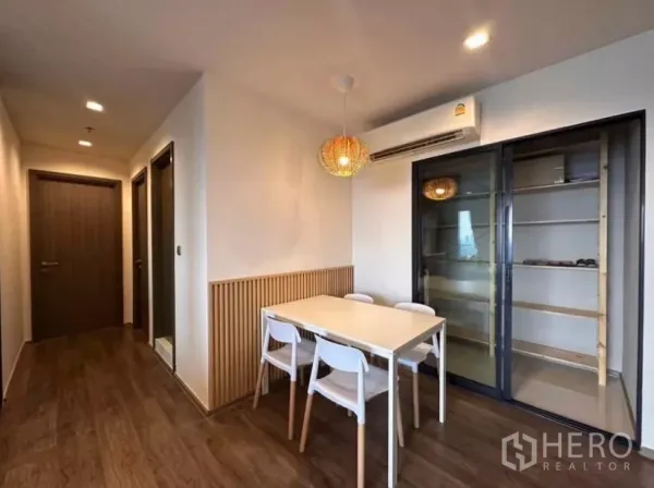 Condominium for rent in Chatuchak, Bangkok - Alternate view of the dining area with sliding storage cabinet and hallway to bedrooms.