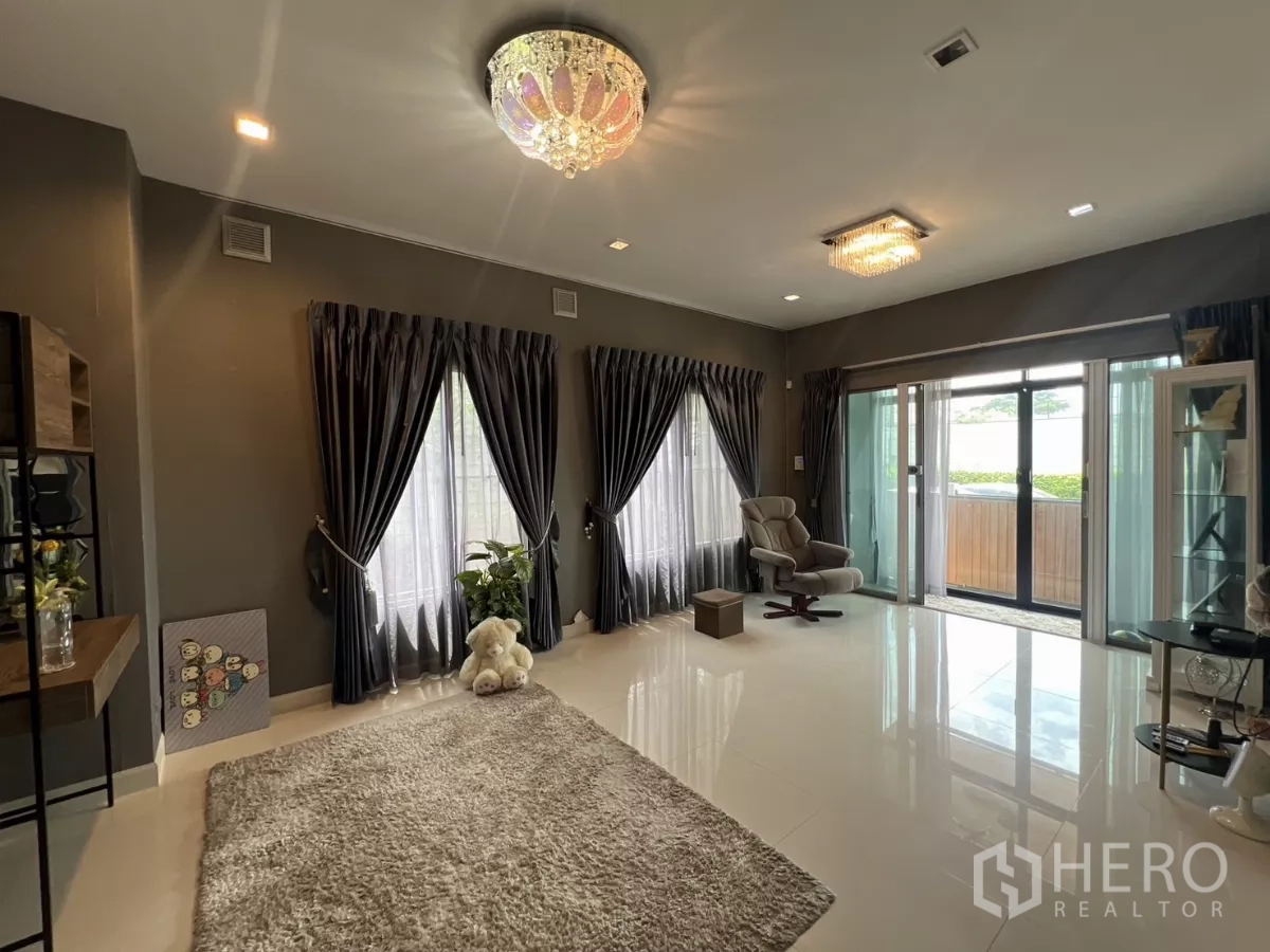 บ้าน ให้เช่าหรือขายในLat Krabang, Bangkok - ห้องนั่งเล่นกว้าง ประตูกระจกบานเลื่อนสู่เฉลียงและพรมฟู