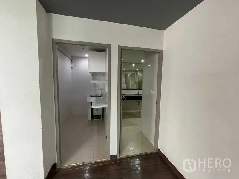 Office Space for rent in Ratchathewi, Bangkok - Pantry and restroom entrances with tiled floors and a single sink.
