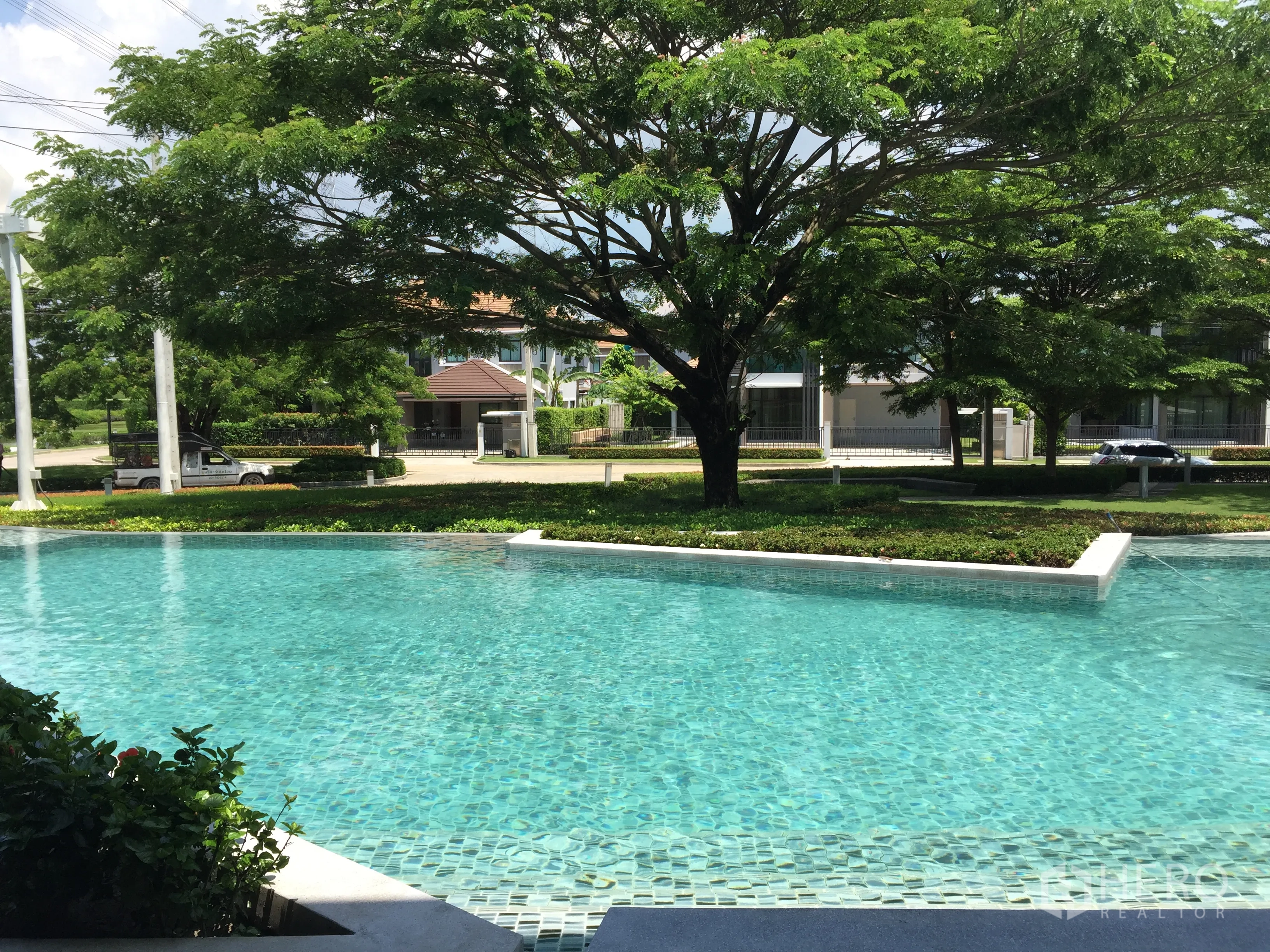 Detached House for sale in Prawet, Bangkok - Communal swimming pool with mature trees and landscaped gardens.