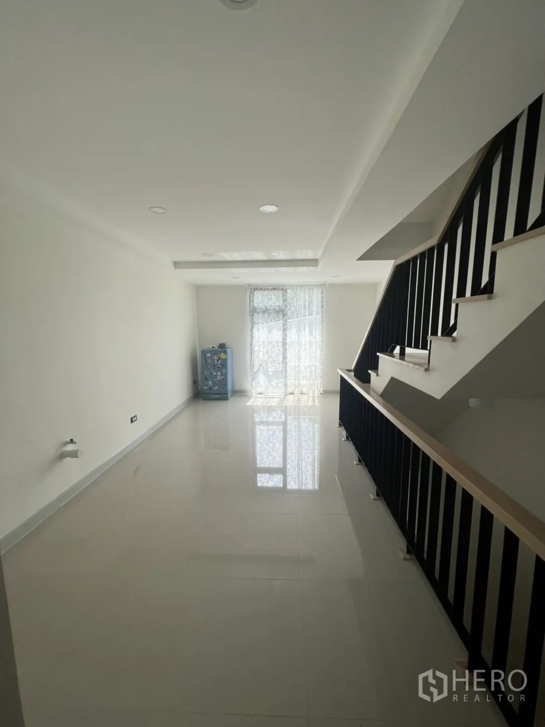 Home Office for rent or sale in Phra Khanong, Bangkok - Elongated hall-like room with balcony door and stair balustrade.