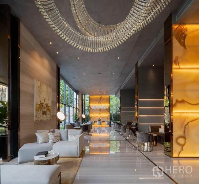 Condominium for rent in Watthana, Bangkok - Grand lobby space with statement chandelier, polished floors, and multiple seating areas.