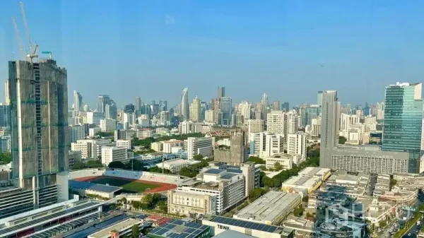 Condominium for rent - Daytime high-floor panorama of Bangkok’s skyline with towers and clear blue sky.