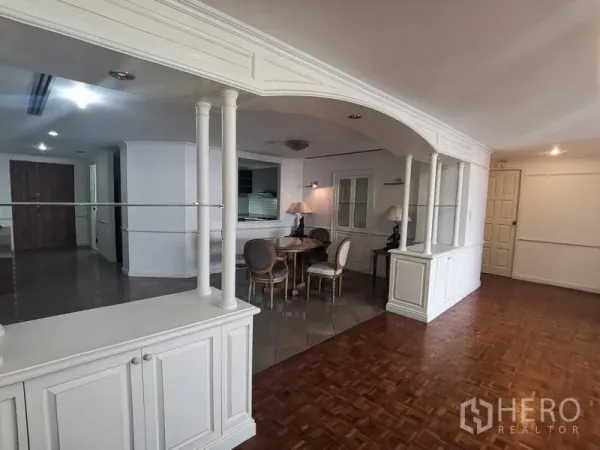 Condominium for rent in Watthana, Bangkok - Open-plan living and dining area with white built-in cabinets and arched display shelves.