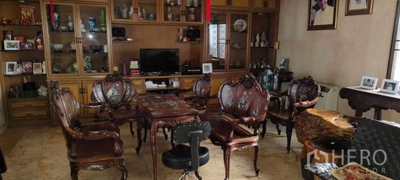 บ้าน ขายในPhra Khanong, Bangkok - ห้องนั่งเล่น เฟอร์นิเจอร์ไม้แกะสลัก และตู้โชว์เต็มผนัง