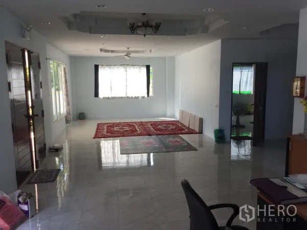 独立式住宅 出租在Saphan Sung, Bangkok - 明亮宽敞的起居室，大窗户、光亮地面与前门视角。