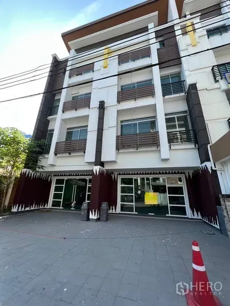 Home Office for sale in Wang Thonglang, Bangkok - Four-storey home office facade with glass storefront and parking area.