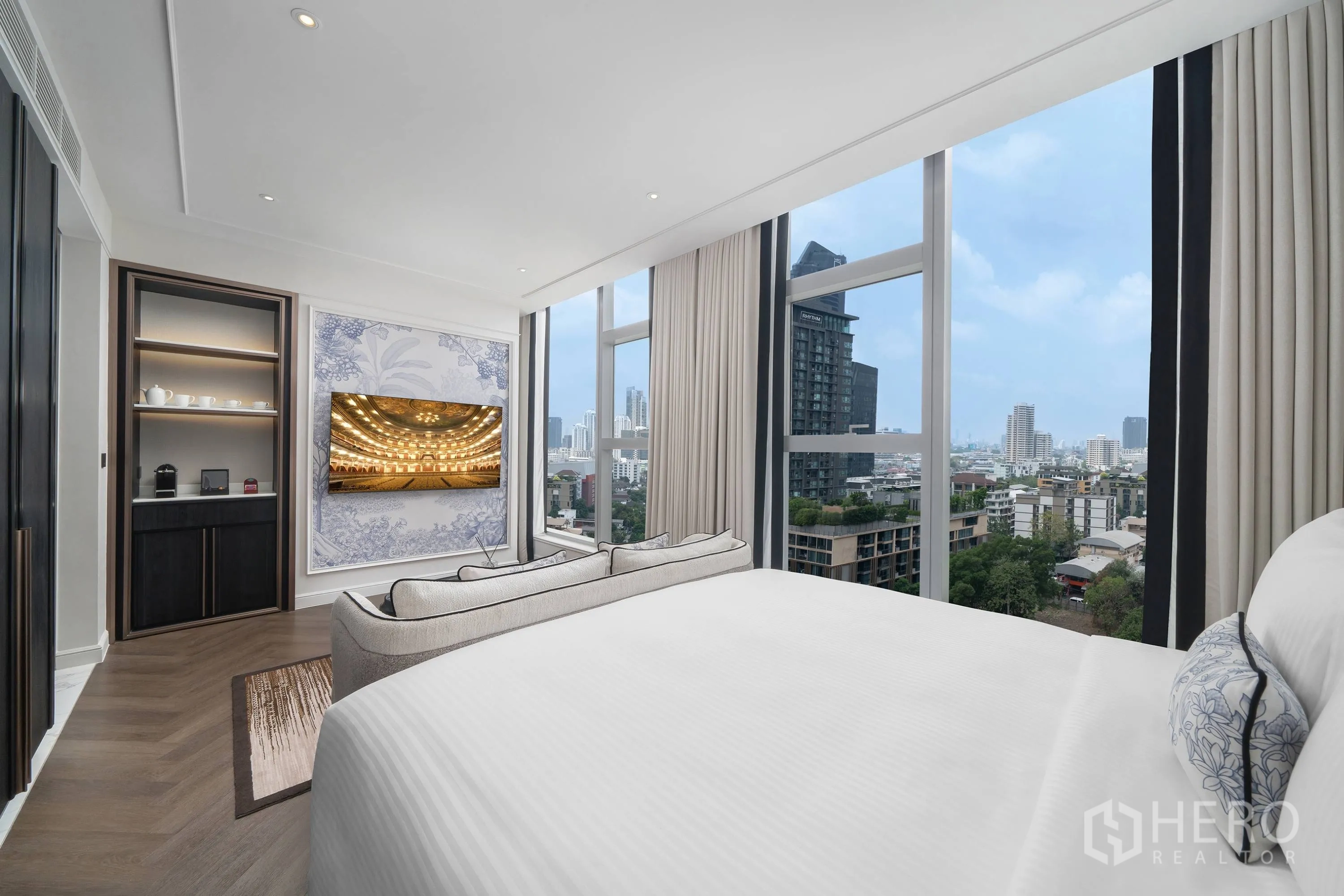 Condominium for rent in Khlong Toei, Bangkok - Bedroom view toward the TV and floor-to-ceiling windows with city views.