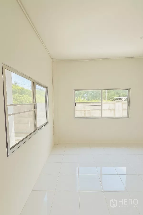 Home Office for rent in Bang Phli, Samut Prakan - Sunlit white room with two sliding windows and shiny floor tiles.
