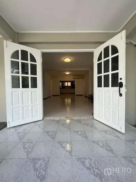 Detached House for rent in Wang Thonglang, Bangkok - White double doors opening into a bright tiled foyer and living area.