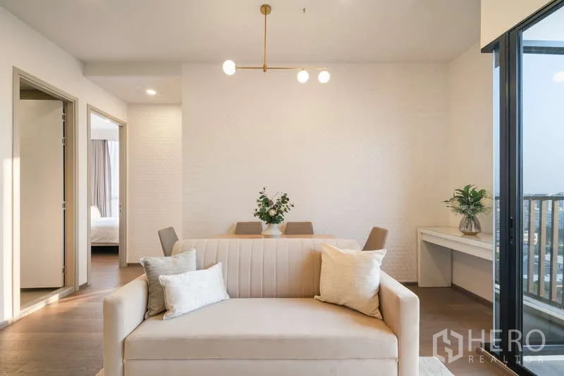 Condominium for rent - Open-plan lounge with sofa, dining set and study nook beside sliding glass door to the balcony.