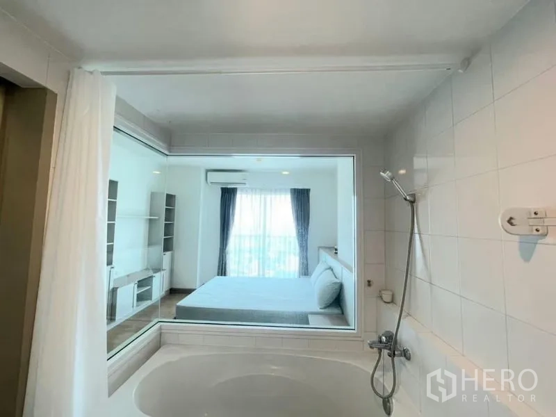 Condominium for sale - En-suite bathroom with bathtub, handheld shower and window to the bedroom.