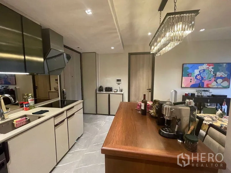 Condominium for rent or sale - Open-plan kitchen with crystal pendant light and dining island