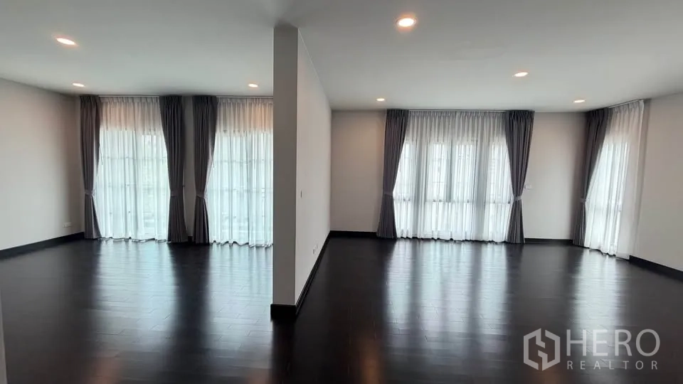 Detached House for rent in Bang Phli, Samut Prakan - Two spacious rooms separated by a partial wall with full-height curtained windows.