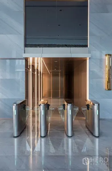 Office Space for rent in Bang Rak, Bangkok - Secure lobby entrance with electronic turnstiles leading to the elevator bank.