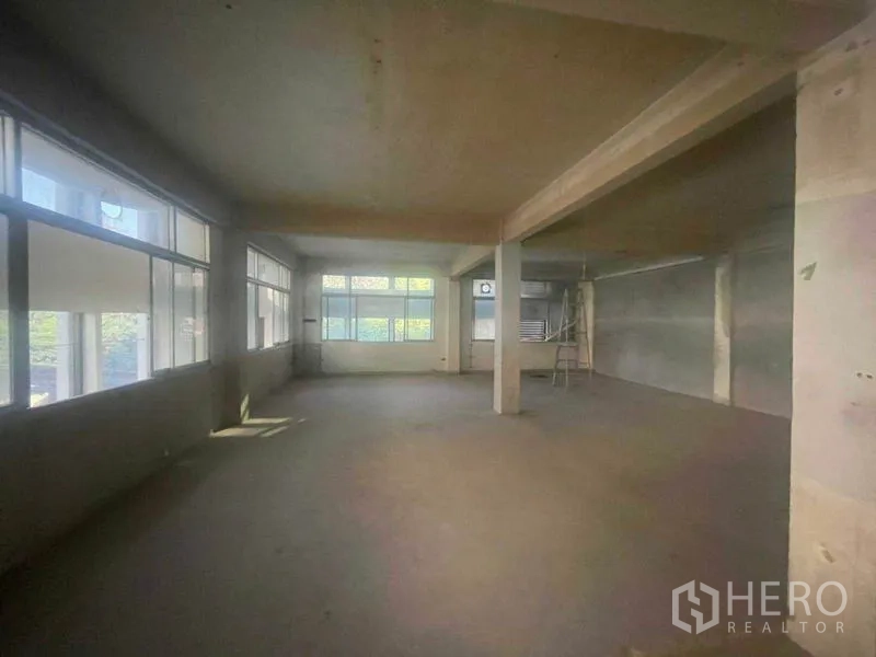 店屋 出租在Watthana, Bangkok - 连排商铺宽敞开放式楼层，混凝土柱与大窗户。