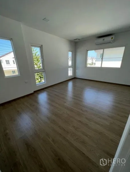 บ้าน ให้เช่าในMin Buri, Bangkok - ห้องนอนมุมบ้านมีหน้าต่างหลายด้าน พื้นลามิเนตและเครื่องปรับอากาศ