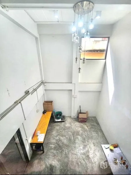 Office Space for rent or sale in Din Daeng, Bangkok - Double-height studio area with pendant lighting and a tall side window.
