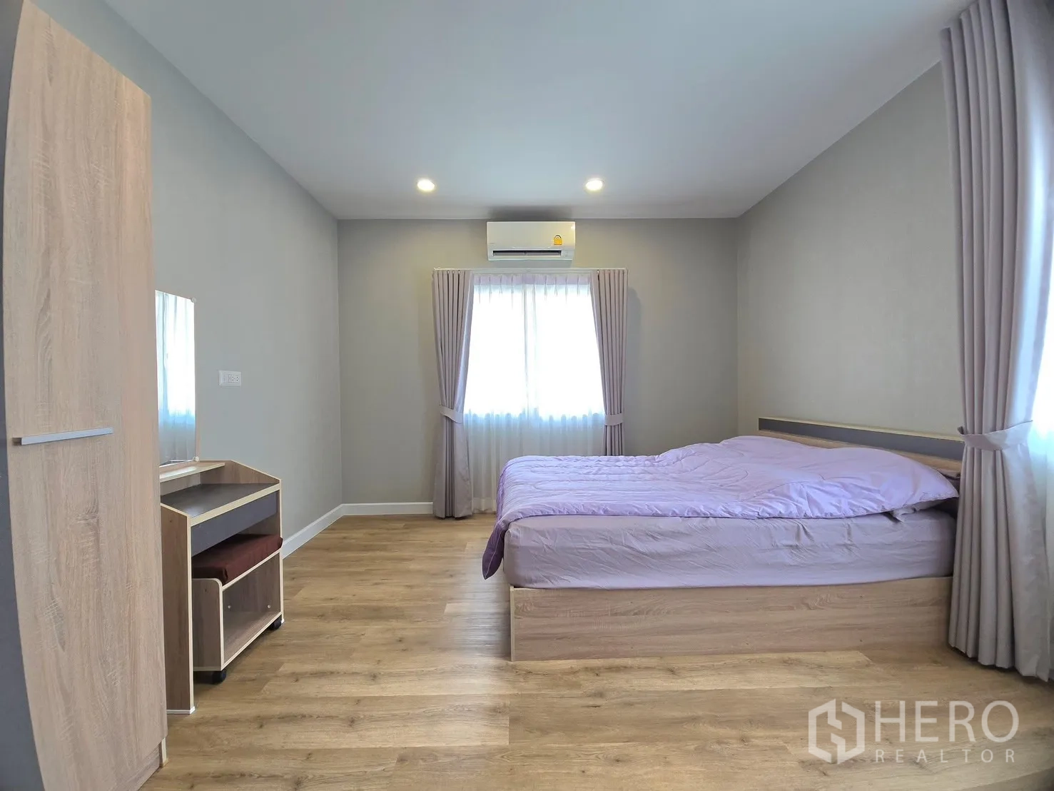 Detached House for rent in Lat Krabang, Bangkok - Bedroom with bed, wardrobe and dressing table under soft lighting.