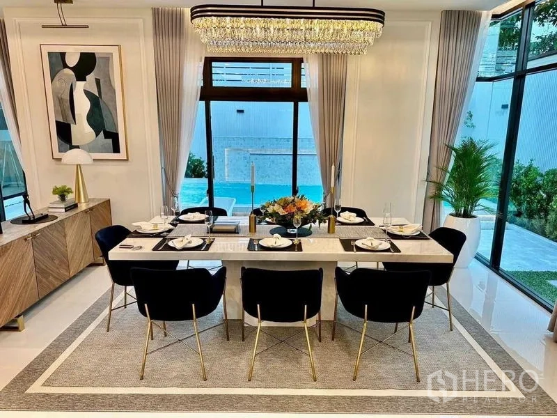 Detached House for rent in Bang Phli, Samut Prakan - Formal dining room set for eight with pool view through tall windows.