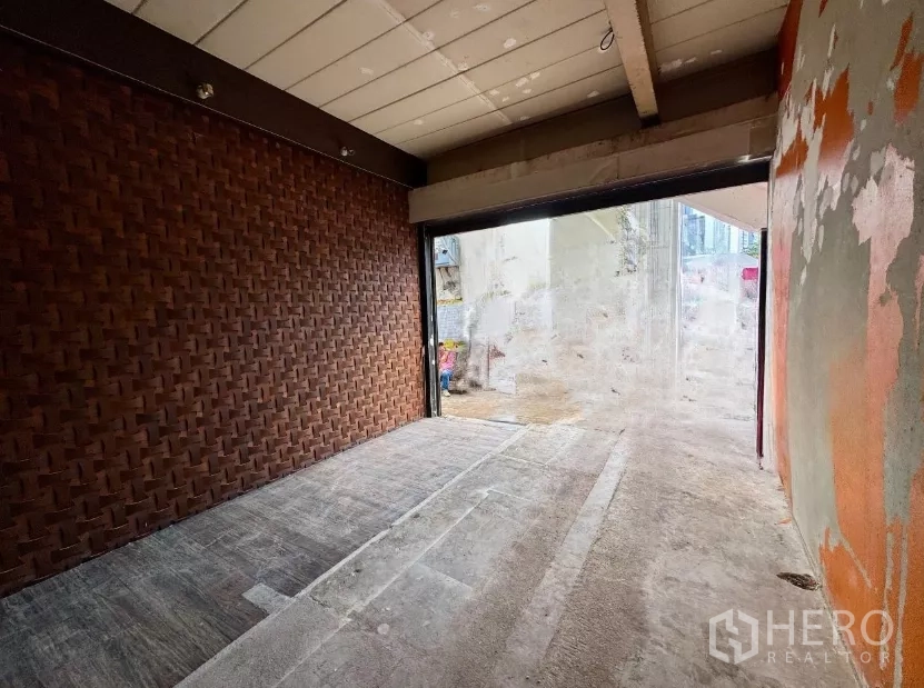 Shophouse for rent in Sathon, Bangkok - Ground-floor shopfront bay with roller shutter opening directly to the street.