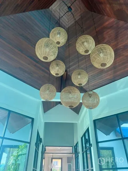 Detached House for sale in Prawet, Bangkok - Double-height foyer with timber ceiling and rattan pendant lights.