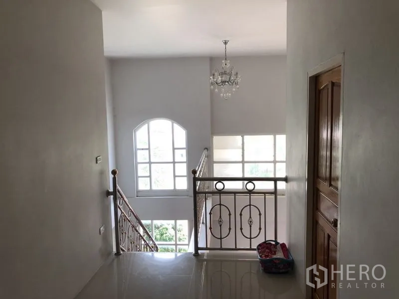 บ้าน ขายในLam Luk Ka, Pathum Thani - โถงชั้นบนพร้อมโคมระย้าและหน้าต่างทรงโค้งสูง